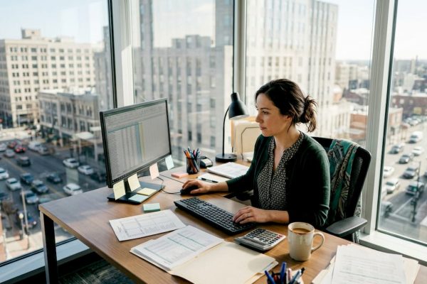 Accountant working at city view office desk
