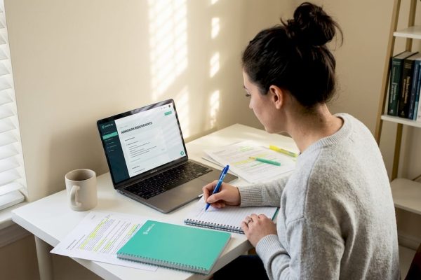 MBA applicant reviews documents at home desk
